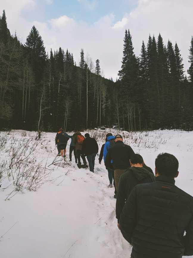 a group of Solidus Conf attendees hiking in the snow in Utah